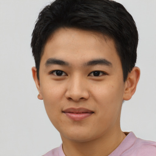 Joyful asian young-adult male with short  black hair and brown eyes