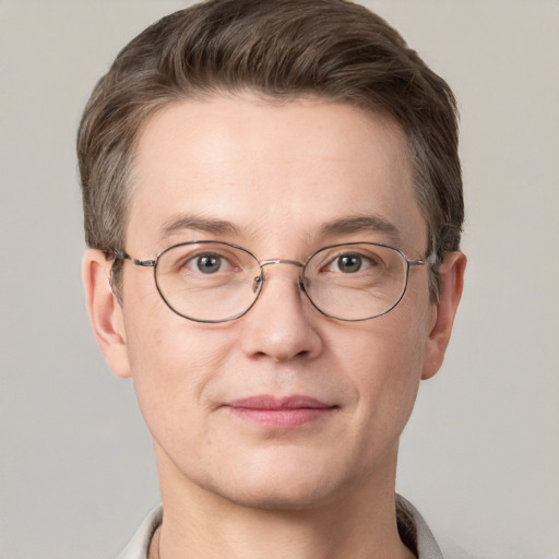 Joyful white adult male with short  brown hair and grey eyes