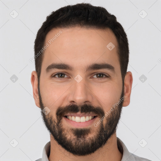 Joyful white young-adult male with short  black hair and brown eyes