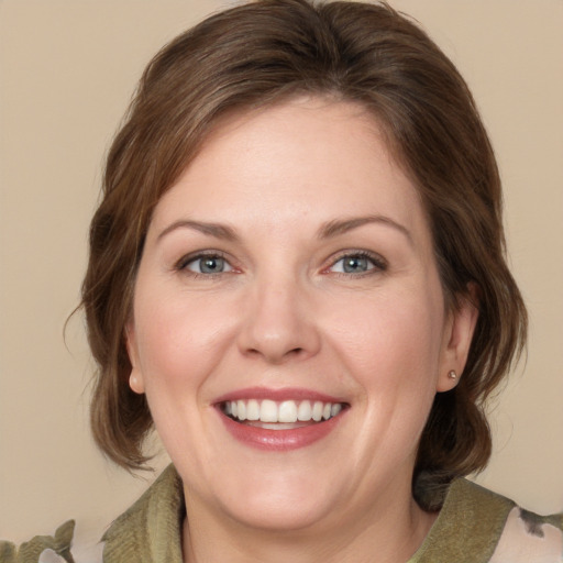 Joyful white young-adult female with medium  brown hair and grey eyes