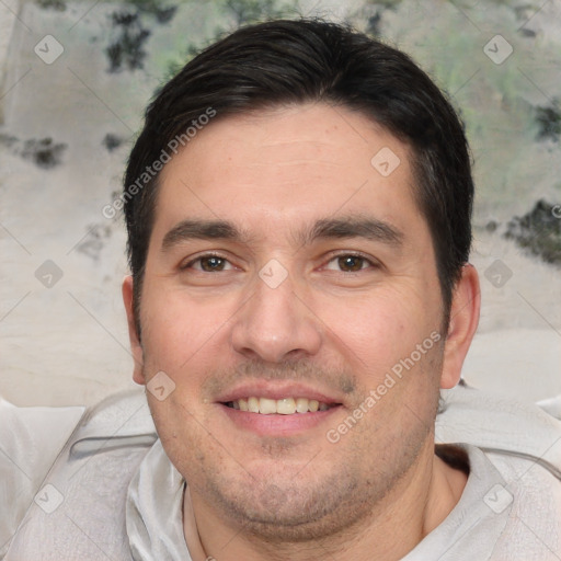 Joyful white adult male with short  black hair and brown eyes