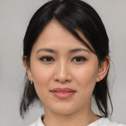 Joyful asian young-adult female with medium  black hair and brown eyes