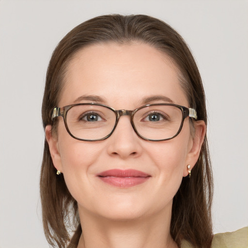 Joyful white young-adult female with medium  brown hair and grey eyes