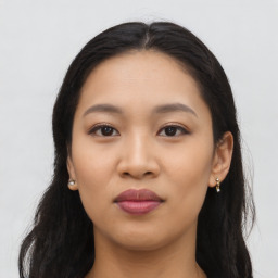 Joyful latino young-adult female with long  black hair and brown eyes