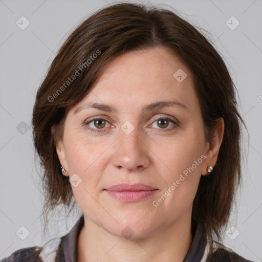 Joyful white adult female with medium  brown hair and grey eyes