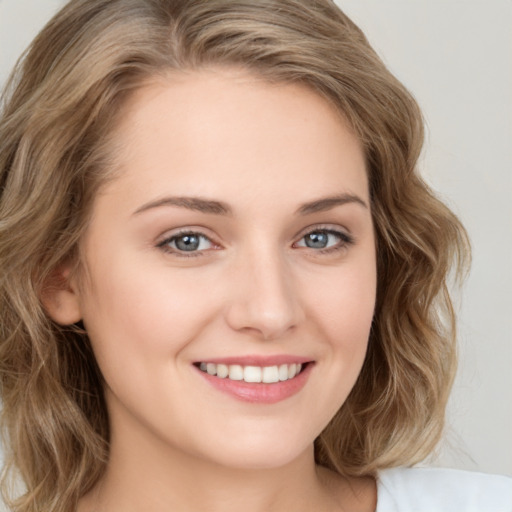 Joyful white young-adult female with long  brown hair and green eyes