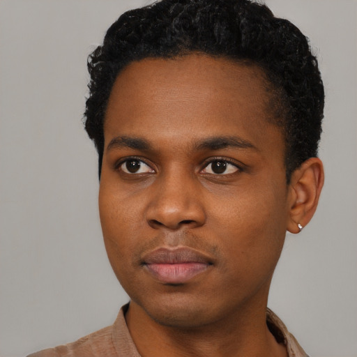 Neutral black young-adult male with short  black hair and brown eyes