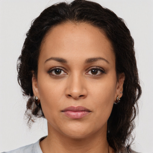 Joyful latino young-adult female with medium  brown hair and brown eyes