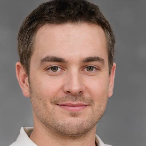 Joyful white young-adult male with short  brown hair and brown eyes