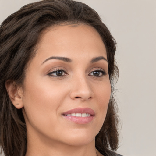 Joyful white young-adult female with long  brown hair and brown eyes