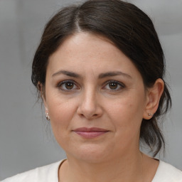 Joyful white adult female with medium  brown hair and brown eyes