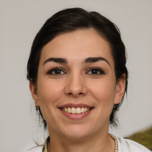 Joyful white young-adult female with medium  brown hair and brown eyes