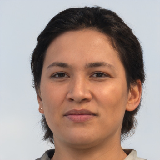 Joyful asian young-adult female with medium  brown hair and brown eyes