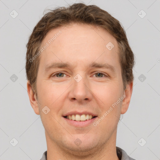 Joyful white adult male with short  brown hair and grey eyes