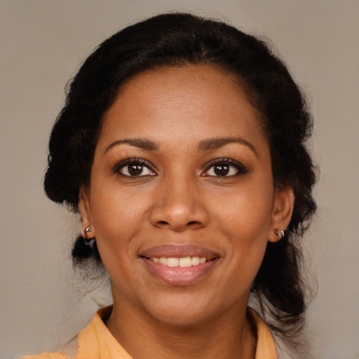 Joyful black young-adult female with medium  brown hair and brown eyes