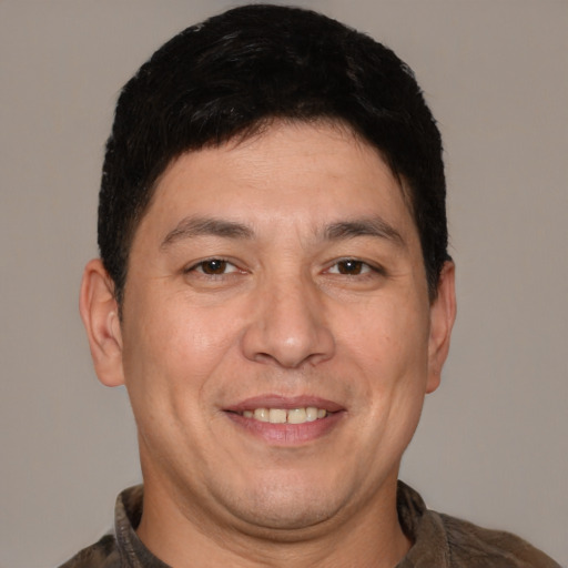 Joyful white adult male with short  brown hair and brown eyes