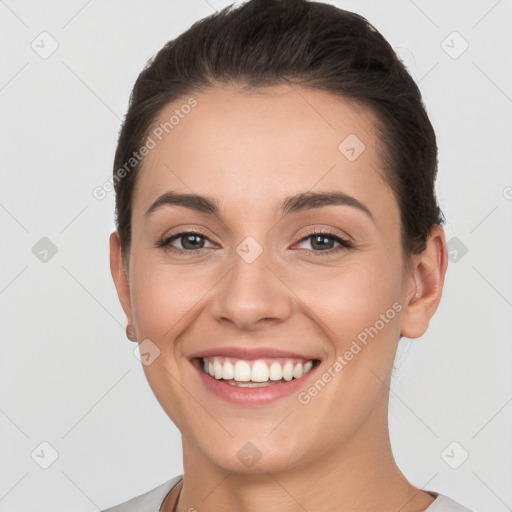 Joyful white young-adult female with short  brown hair and brown eyes