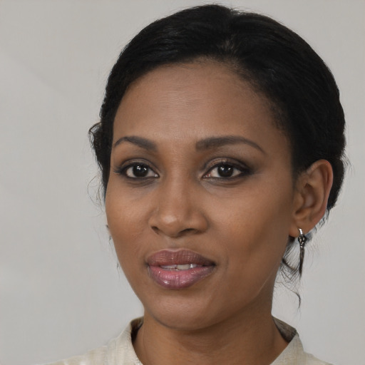Joyful black young-adult female with medium  black hair and brown eyes