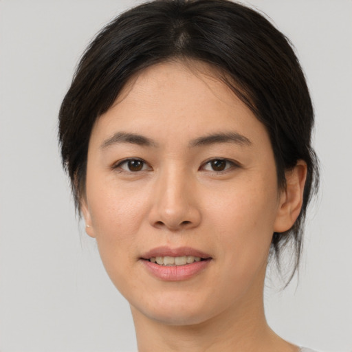 Joyful white young-adult female with medium  brown hair and brown eyes