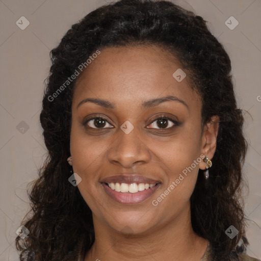 Joyful black young-adult female with long  brown hair and brown eyes