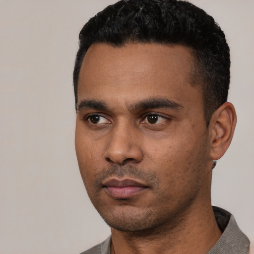 Neutral latino young-adult male with short  black hair and brown eyes