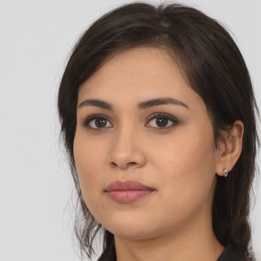 Neutral latino young-adult female with long  brown hair and brown eyes