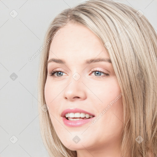 Joyful white young-adult female with long  brown hair and blue eyes