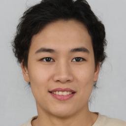 Joyful asian young-adult female with short  brown hair and brown eyes