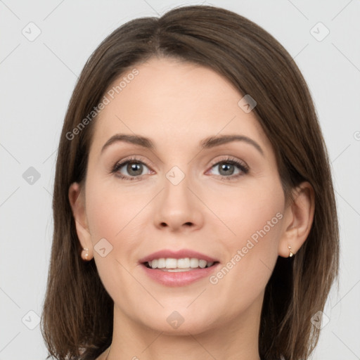 Joyful white young-adult female with long  brown hair and grey eyes