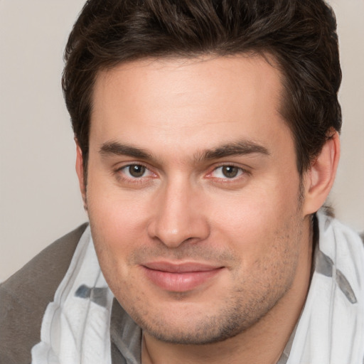 Joyful white young-adult male with short  brown hair and brown eyes