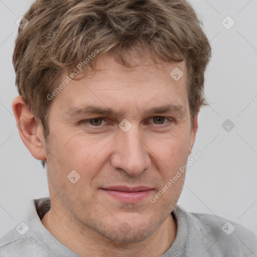 Joyful white adult male with short  brown hair and grey eyes