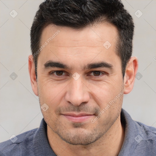 Joyful white adult male with short  brown hair and brown eyes