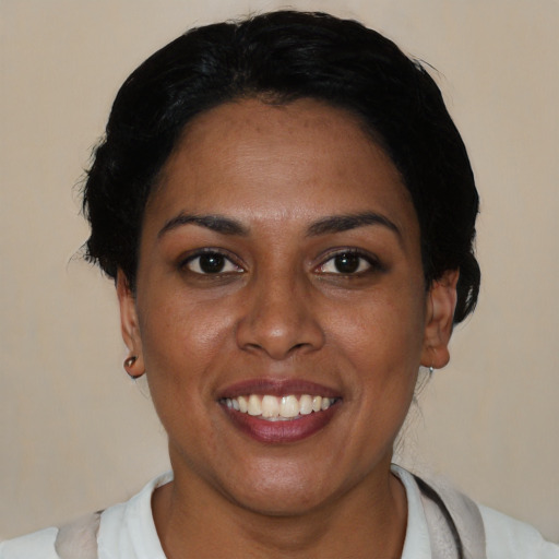 Joyful latino young-adult female with short  brown hair and brown eyes
