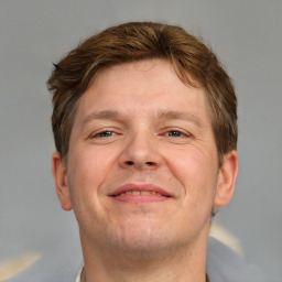 Joyful white adult male with short  brown hair and brown eyes