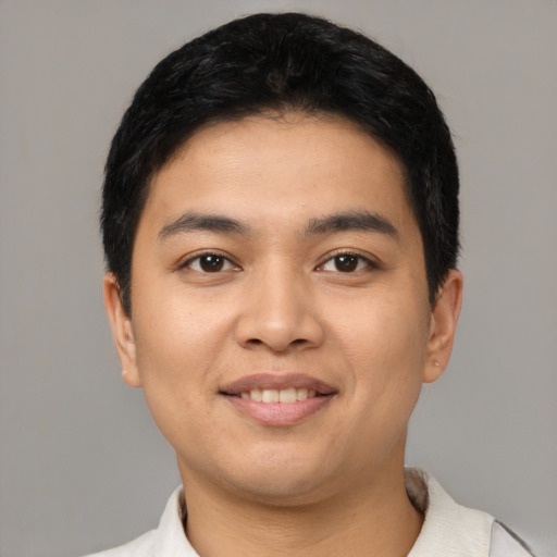 Joyful latino young-adult male with short  black hair and brown eyes