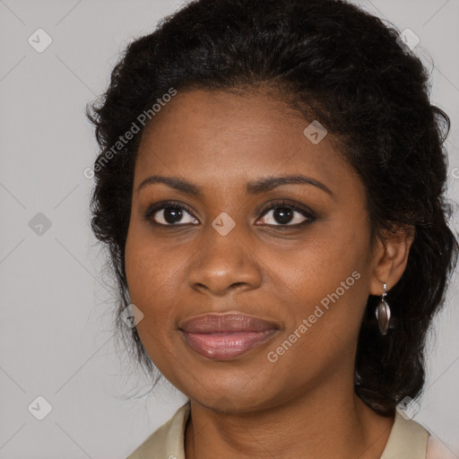 Joyful black young-adult female with long  brown hair and brown eyes