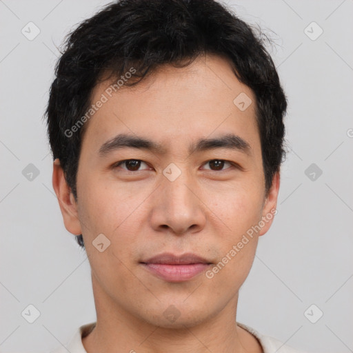 Joyful asian young-adult male with short  brown hair and brown eyes