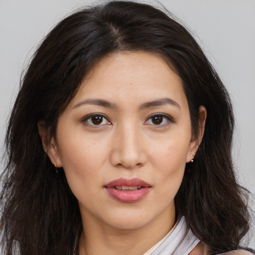 Joyful white young-adult female with long  brown hair and brown eyes