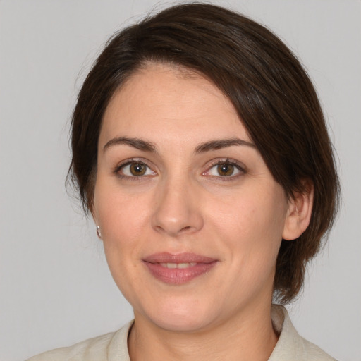 Joyful white adult female with medium  brown hair and brown eyes