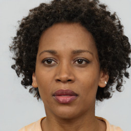 Joyful black adult female with short  brown hair and brown eyes