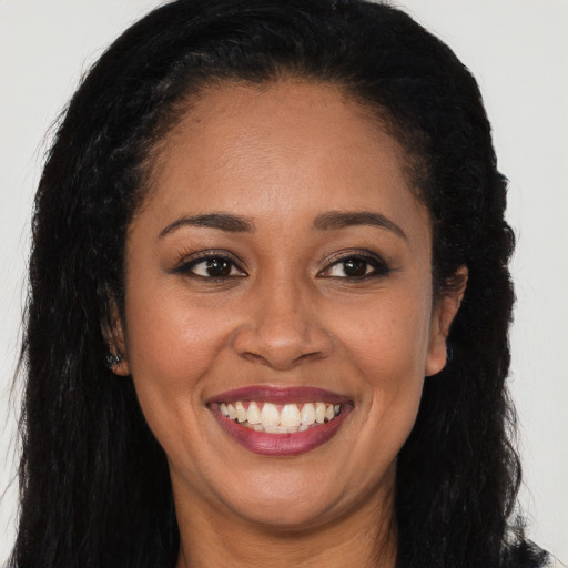 Joyful latino young-adult female with long  brown hair and brown eyes