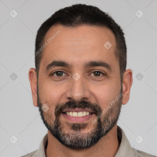 Joyful white adult male with short  black hair and brown eyes