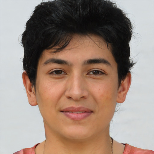 Joyful latino young-adult male with short  brown hair and brown eyes