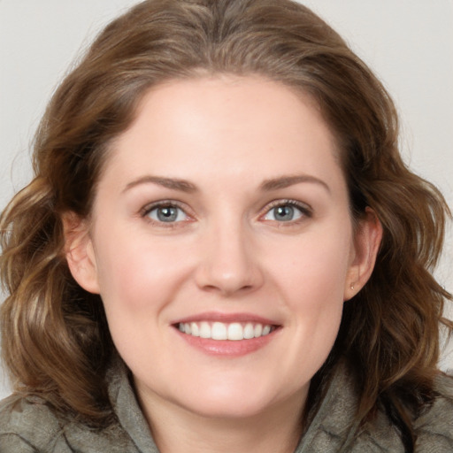 Joyful white young-adult female with medium  brown hair and blue eyes