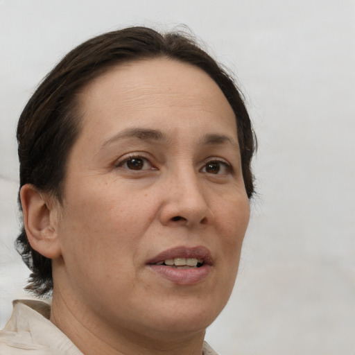 Joyful white adult female with medium  brown hair and brown eyes