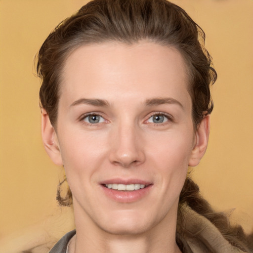 Joyful white young-adult female with medium  brown hair and grey eyes