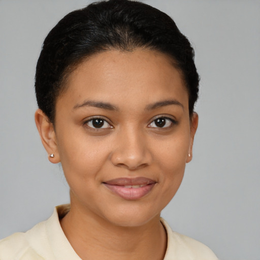 Joyful latino young-adult female with short  brown hair and brown eyes