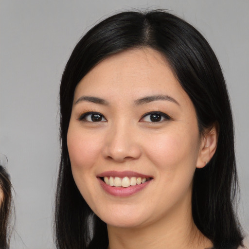 Joyful asian young-adult female with medium  black hair and brown eyes