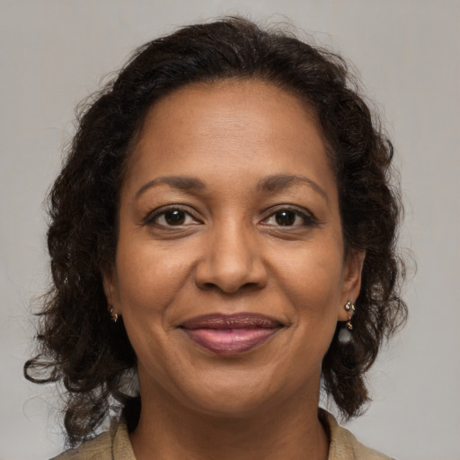 Joyful black adult female with medium  brown hair and brown eyes
