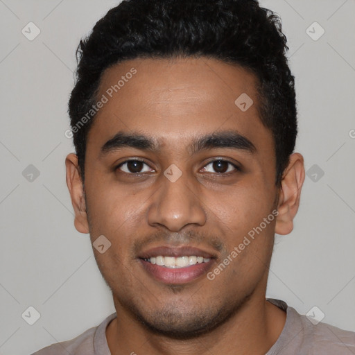 Joyful black young-adult male with short  black hair and brown eyes